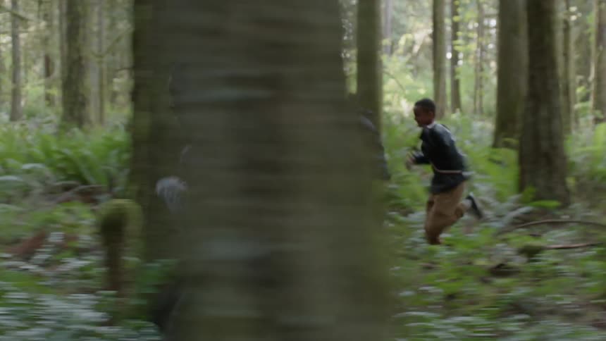 Teenagers run though a forest