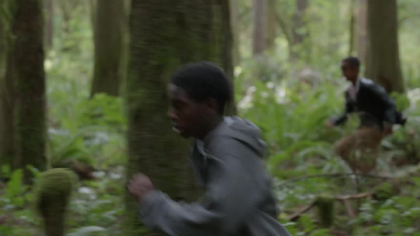 Teenagers run through a forest