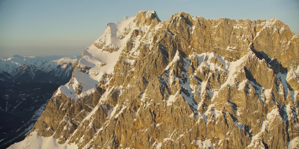 The tall mountains reach up into the clear sky