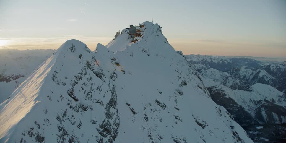 Snow-covered mountains at a somewhat cloudy sunset