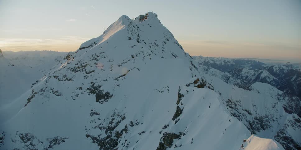 Sunlight shines on snow covered mountain peaks