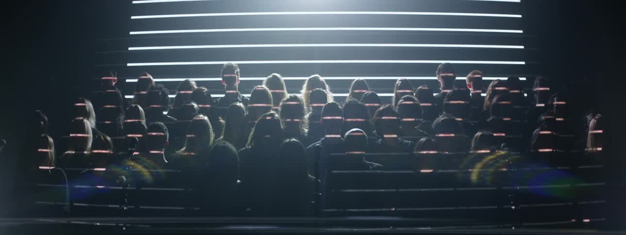 Lights are projected on a singing choir