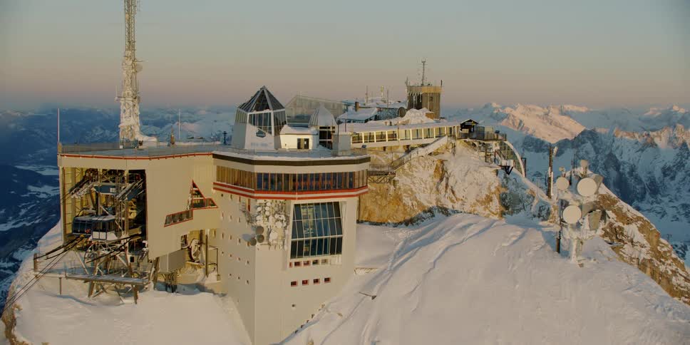 A building sits on a snowy mountain peak