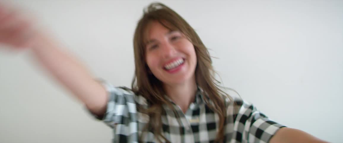 A woman smiles while dancing
