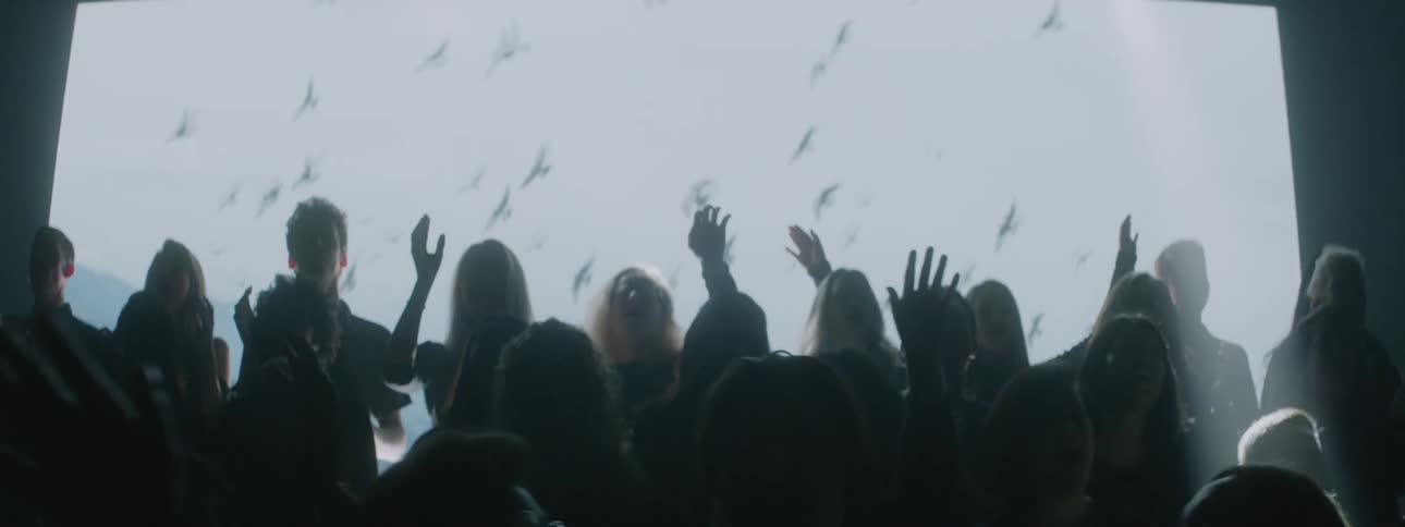 A projection plays behind a singing choir