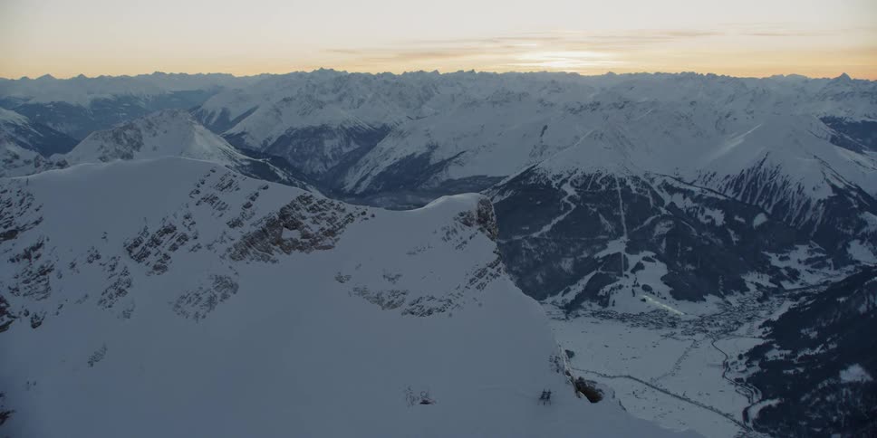 Snow-covered mountains at a somewhat cloudy sunset