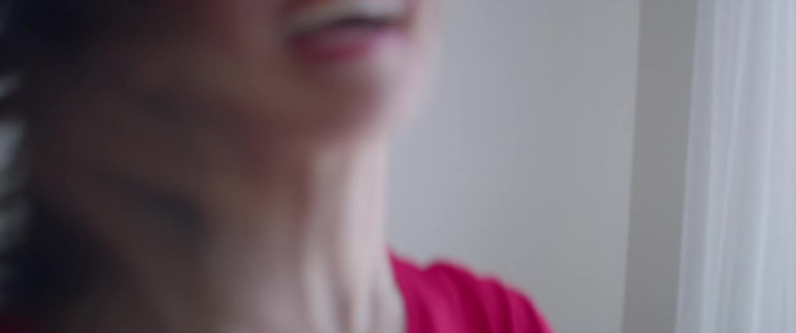 Woman twirling and flipping her hair indoors