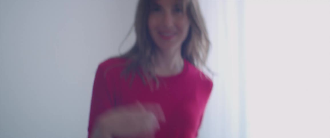A woman is dancing by the window
