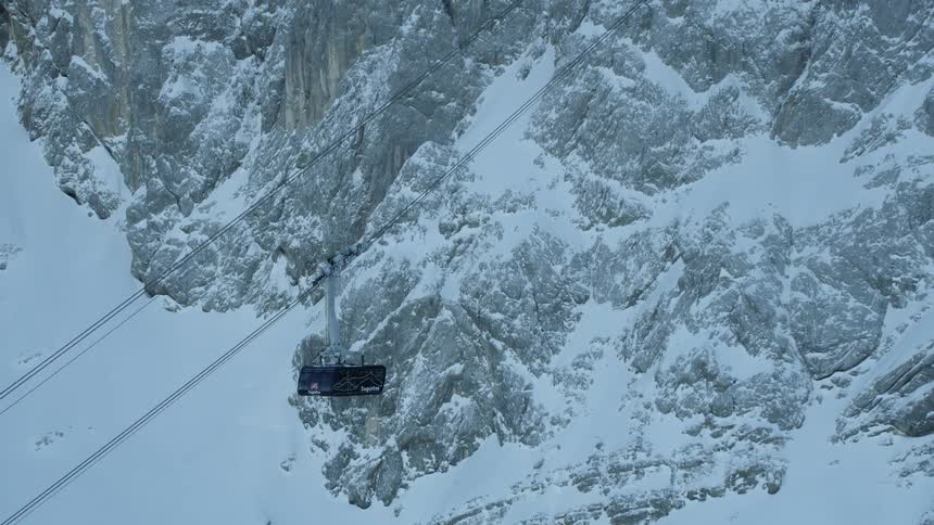 Gondolas and lifts move up a mountain