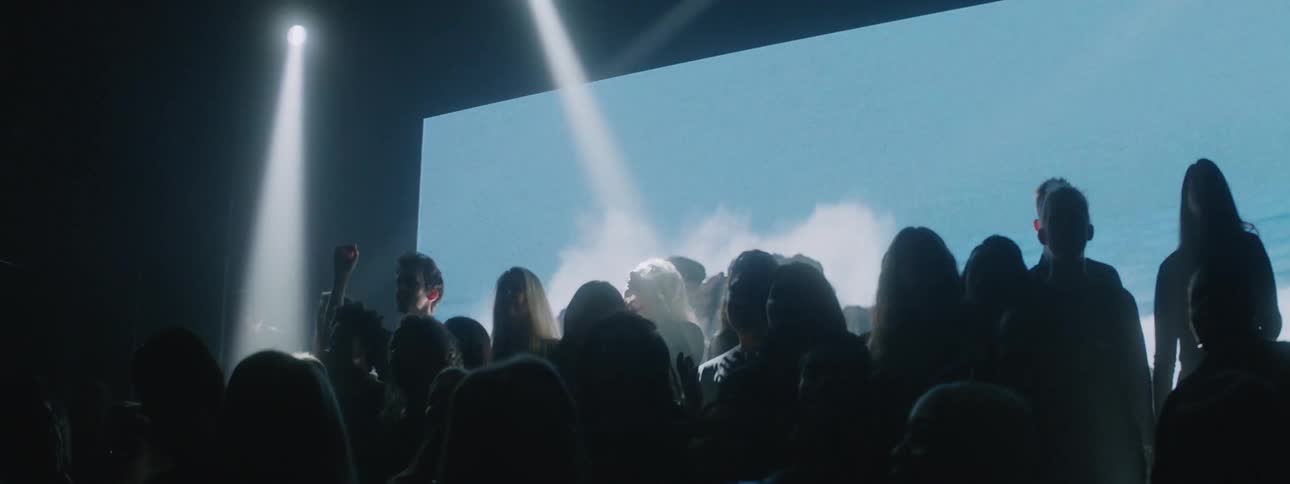 The group of people sing and dance on stage