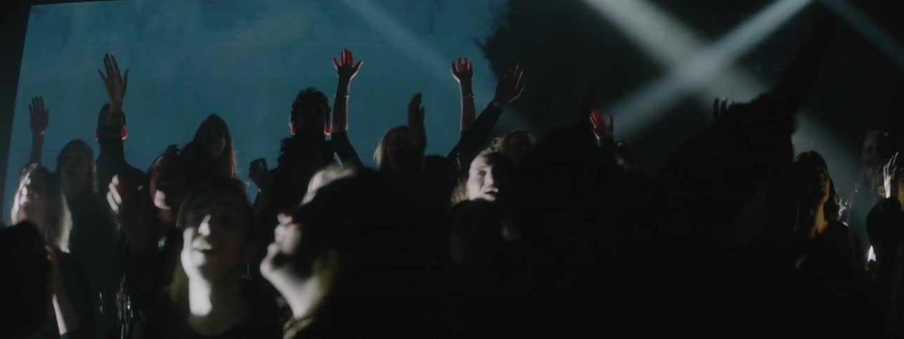 A projection plays behind a singing choir