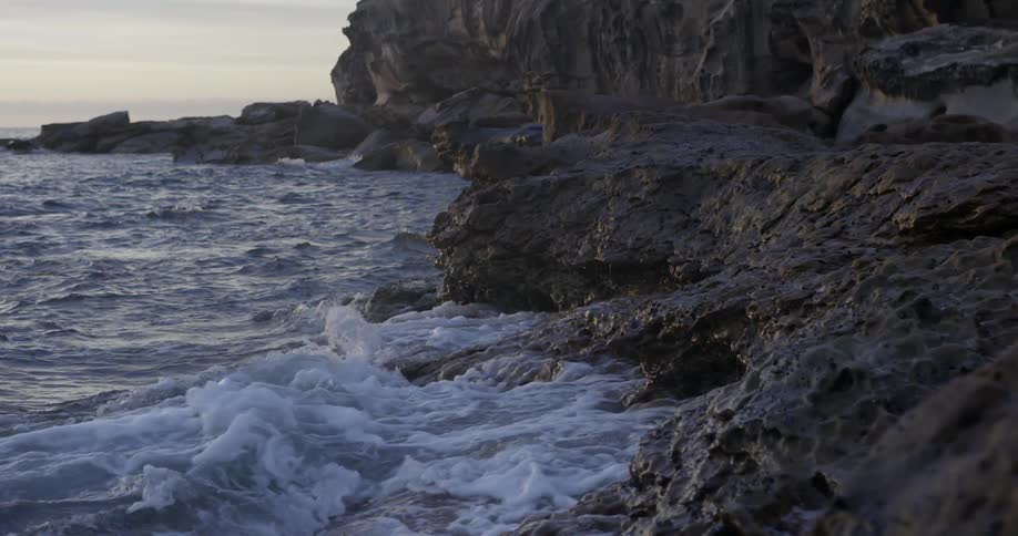 Waves crash against a rocky shore