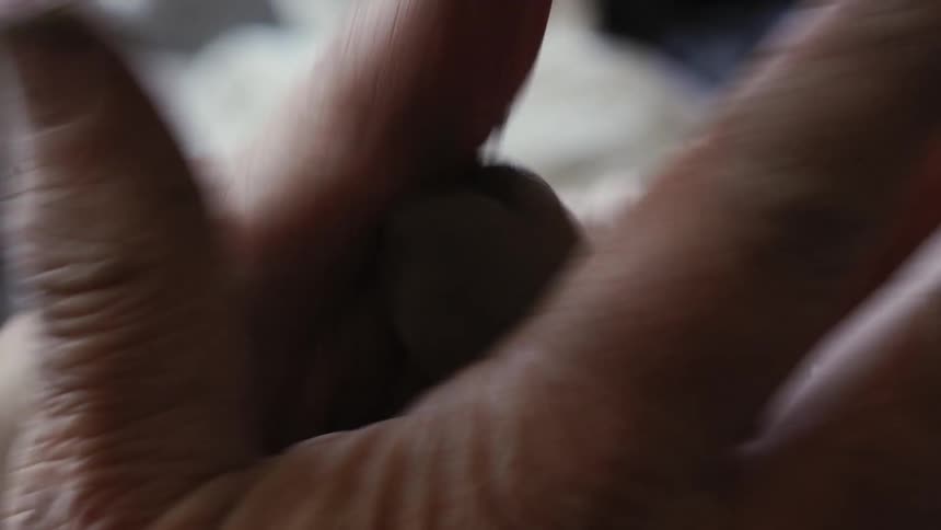 A person rubs clay between their hands