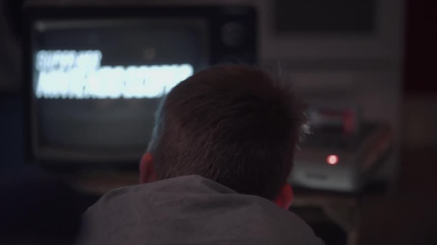 Boy is starting a video game in room
