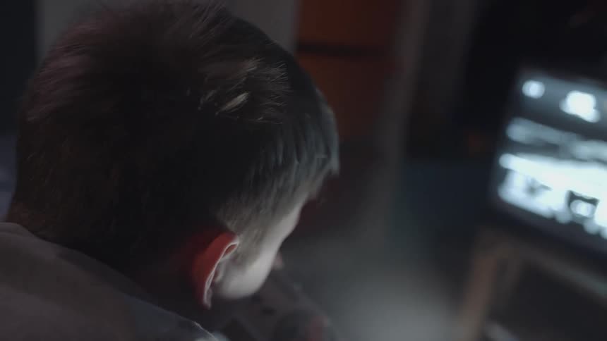 A boy plays a video game on a small television