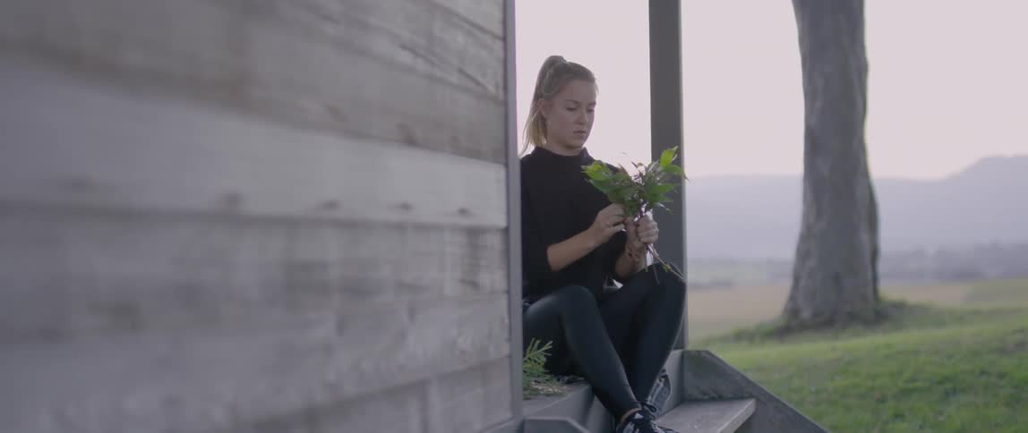 A person sitting holding a plant