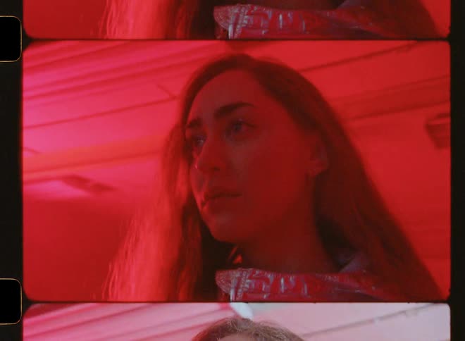 Woman stands in a room with blinking red and white lights