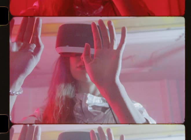 A woman uses virtual reality as the lights flash on her