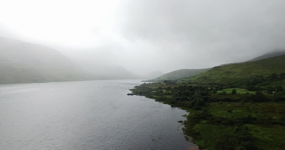 Green hills next to the sea on a very cloudy day