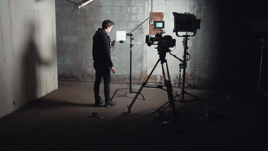 The man is setting up for a film shoot