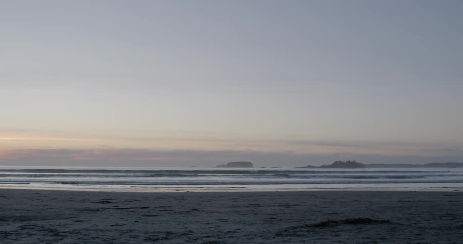 Ocean waves wash ashore at sunset