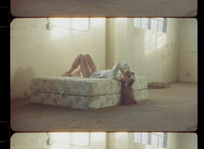 A woman laying down using a virtual reality headset waves