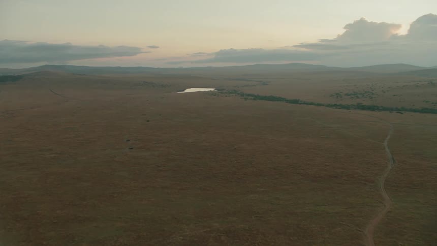 Clouds float above a rural landscape at sunset