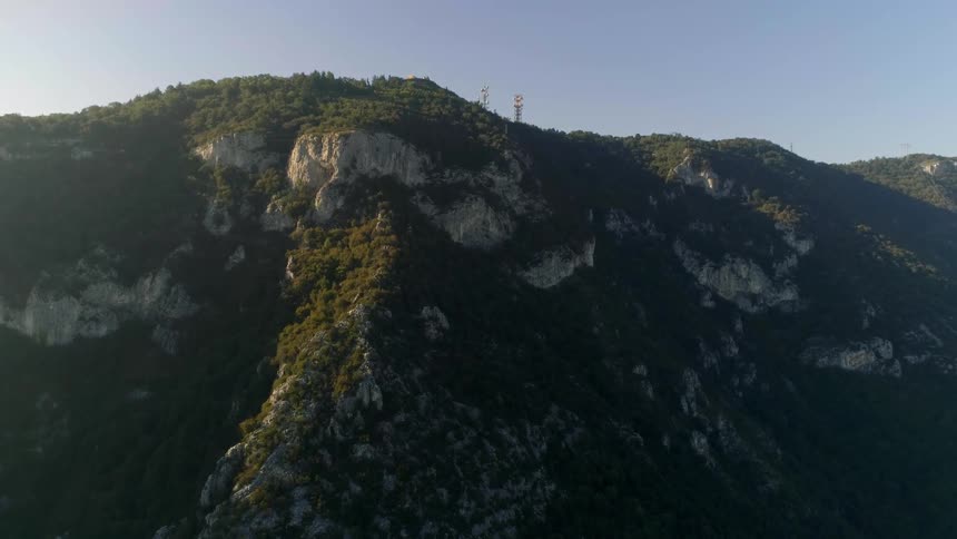 Trees cover a rocky mountain landscape