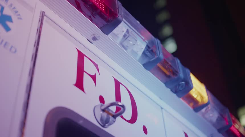 Lights flash on an ambulance at night