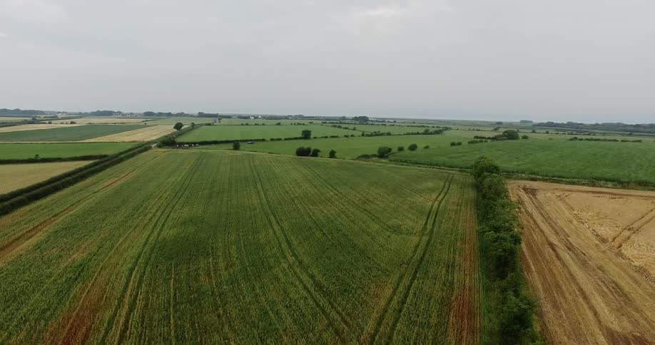 It is cloudy over the long green farmlands