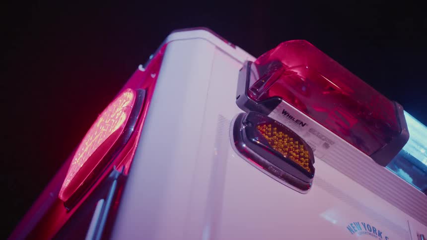 Lights flashing on ambulance at night