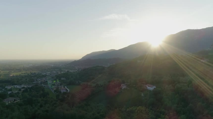The sun shines over a mountain ridge