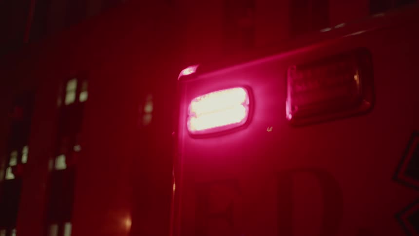 The lights on the ambulance flash at night