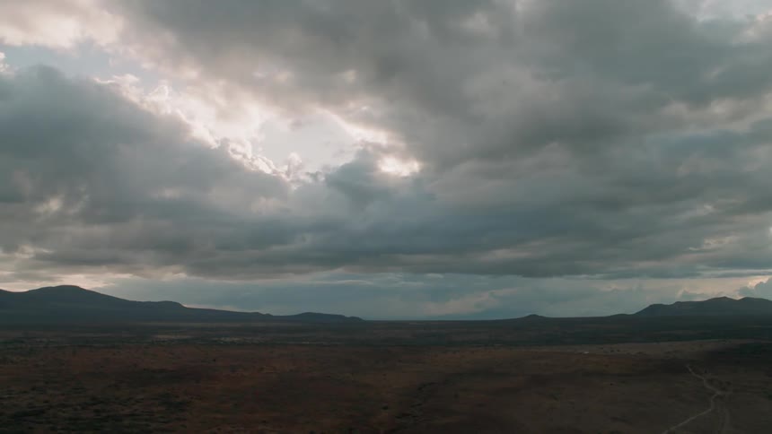 Grey clouds hang above the open land