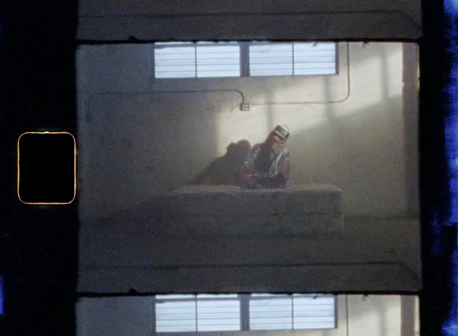 A woman is using a virtual reality headset while sitting on the bed