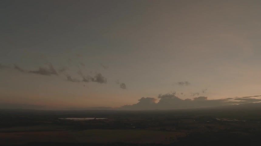 Clouds float in the sky at sunset