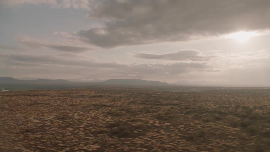 Clouds are hovering over a desert landscape during the day