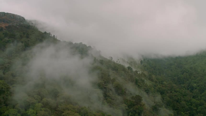 The fog and clouds are rolling over the hills