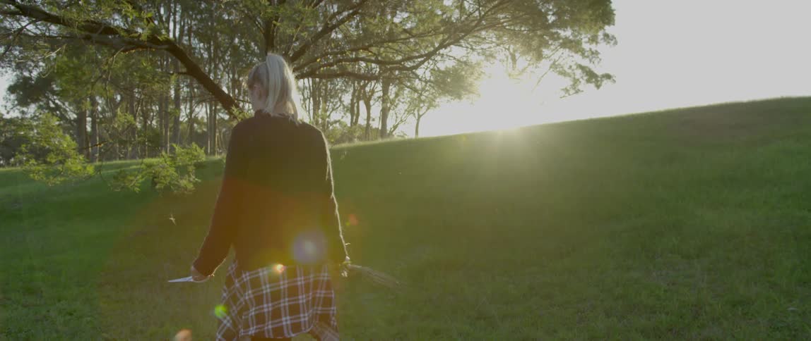 A person is walking through a park