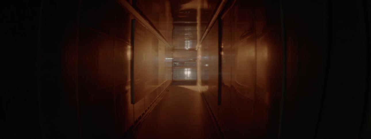 Lights flash and glow at the end of a hallway