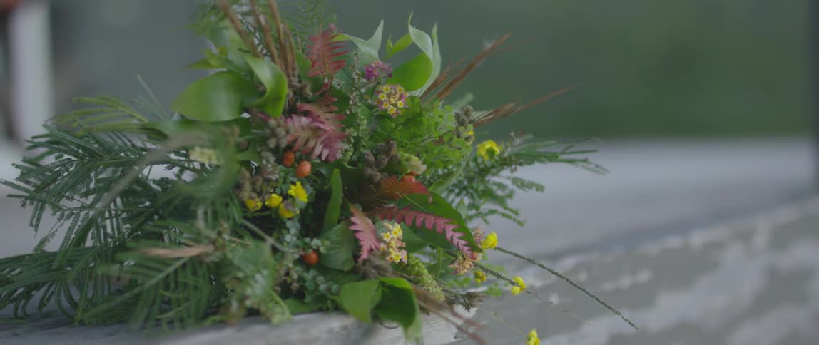 A bouquet of plants and flowers lays on its side