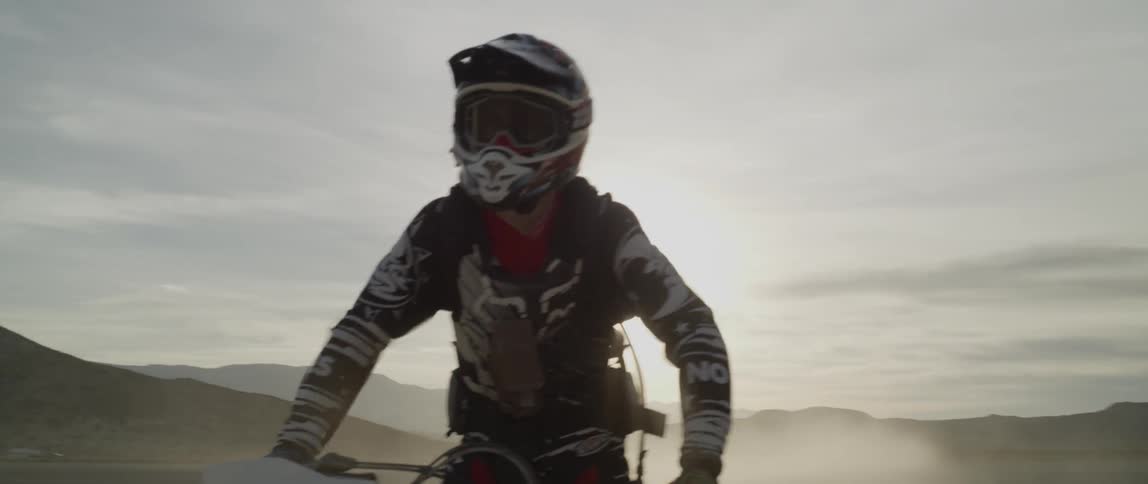 A man rides an atv through the desert