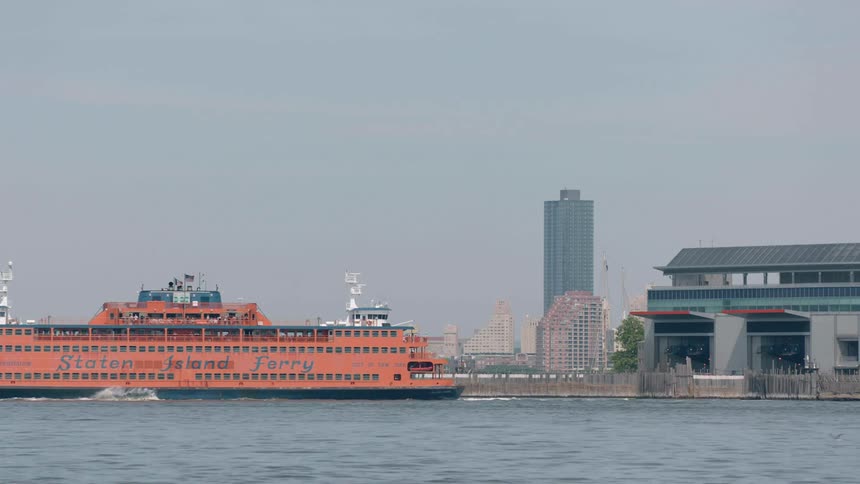 A large ferry boat pushes off from a dock