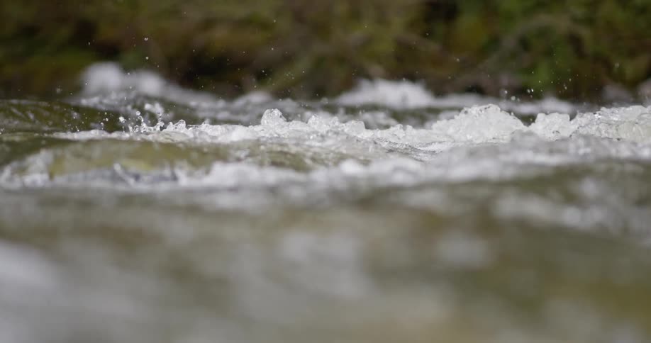 Water splashes and flows in a river