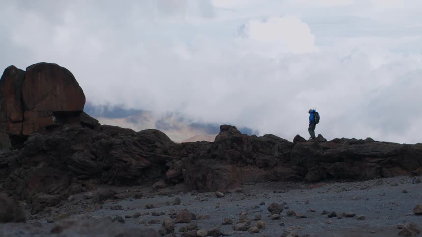 Person hikes on rocky land