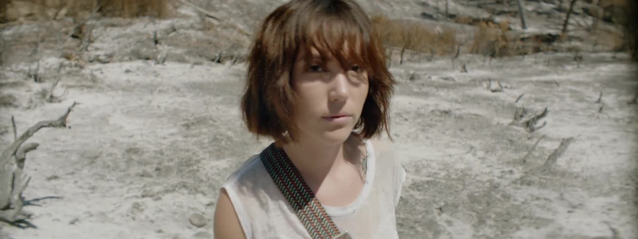 Woman walks in the desert on a sunny day