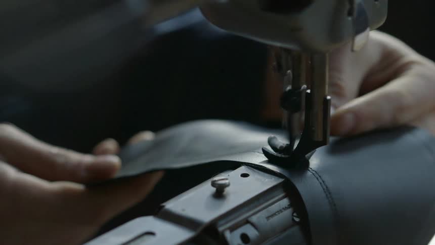 A woman sews a piece of fabric