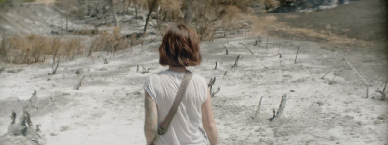A photographer walks in a desert
