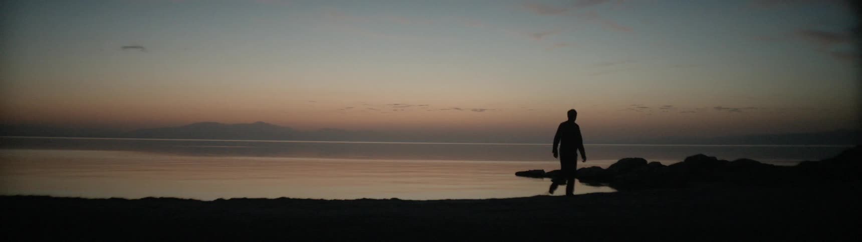 A man walks along the beach