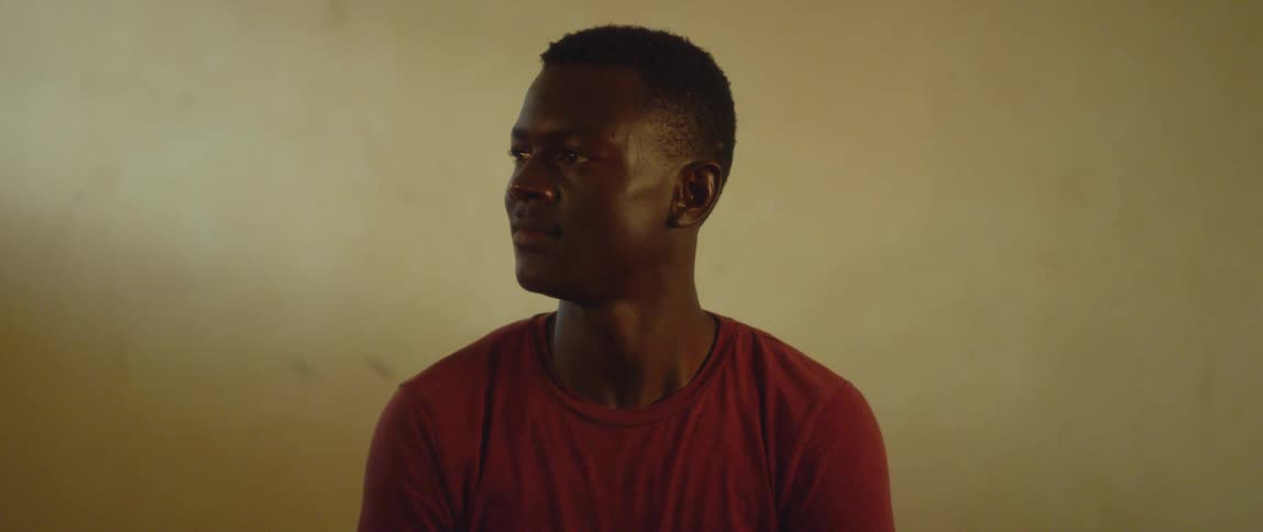 A man stares to his side and blinks